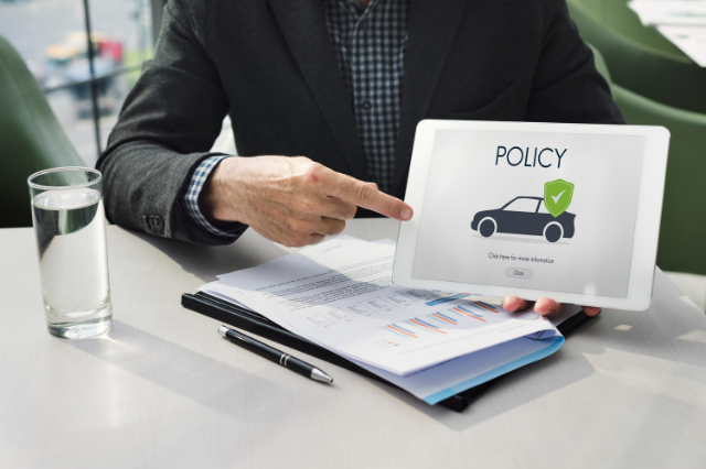Agent presenting a car insurance policy on a tablet