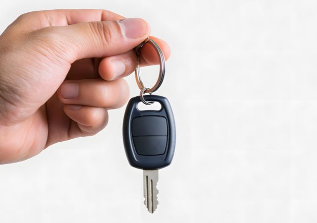 Hand holding a car key